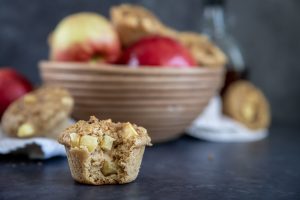 Apple Cinnamon Muffins near a bowl of apples